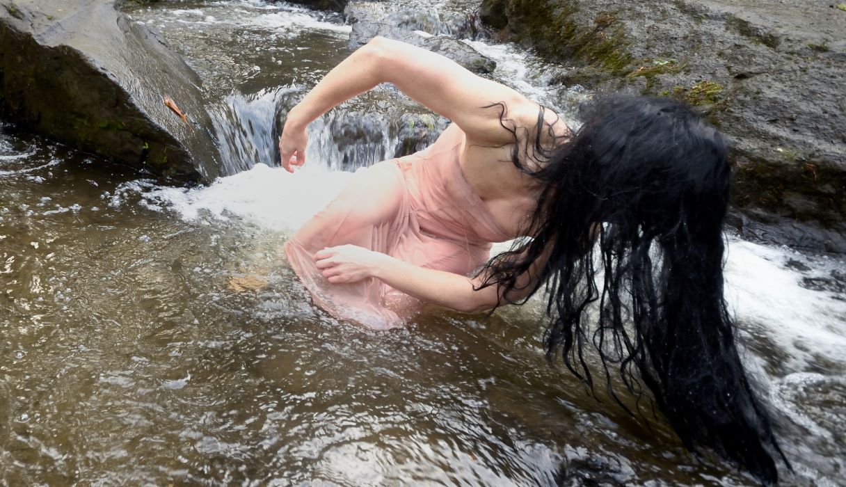 female dancer performing in a river