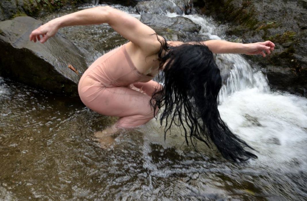 female dancer performing in a river