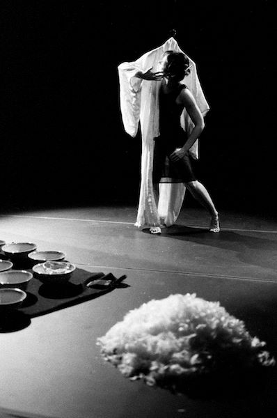 female dancer moving on stage with a suspended silk kimono that looks like a floating figure 