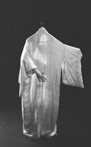 arm poking through a suspended silk kimono that looks like a floating figure
